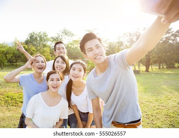 happy young group taking selfie in the park - Powered by Shutterstock