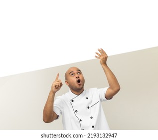 Happy Young Handsome Asian Man Chef In Uniform Holding An Empty Whiteboard. Cooking Indian Man With Big Blank Billboard For Advertising Text Menu In Kitchen And Restaurant.