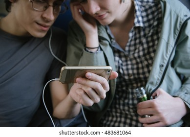 Happy Young Hipster Couple  Watch Together On-line Movie In Rail Car. 