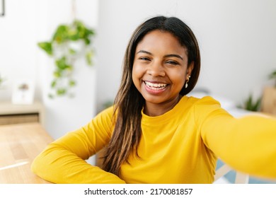 Happy Young Hispanic Latina Teenager Girl Taking Selfie Portrait With Mobile Phone App On Bedroom