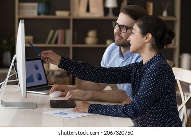 Happy young Indian employee discussing online project with skilled male team leader boss, developing corporate growth strategy or reviewing statistics data, collaborating in modern office room. - Powered by Shutterstock