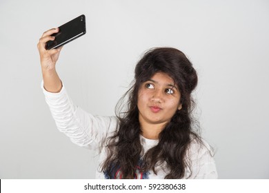 Happy Young Indian Girl Taking A Selfie.