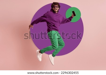 Happy young Indian man in headphones jumping against colorful background
