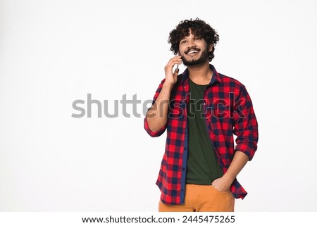 Happy young Indian man talking on the smart phone with friends isolated over white background. Hindi freelancer consulting customers via mobile communication