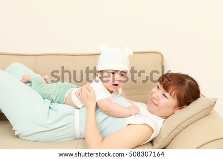 happy young Japanese mom and her baby