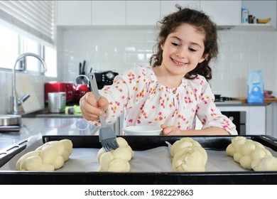 Happy Young Jewish Girl (female Age 7) Baking Sweet Challah Bread For Sabbath Jewish Holiday In Home Kitchen.