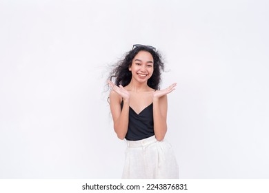 A happy young lady clapping in approval. Wearing a black spaghetti strap blouse. Isolated on a white background. - Shutterstock ID 2243876831