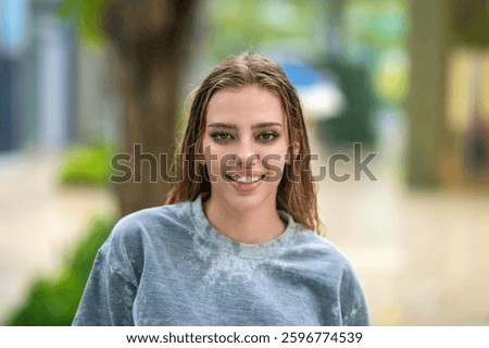 Happy young lady looking on camera and smiling. Beautiful smiling young woman. Pretty girl smiling with perfect smile. Happy and smiling female face. Portrait of authentic happy woman.
