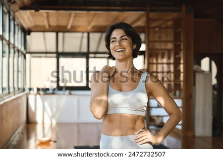 Image, Stock Photo Young woman trainer teaching the different exercises to a student while they exercise with a smile.