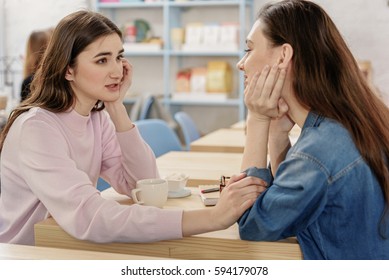 Happy young lesbian couple in cafe - Shutterstock ID 594179078
