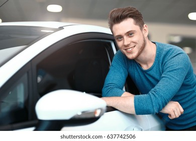 Happy Young Male Buyer In A Car Dealership