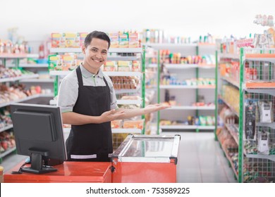 happy young male shopkeeper welcoming customer - Shutterstock ID 753589225