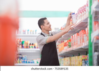 Happy Young Male Staff Working At Super Market