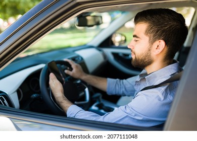 Happy Young Man Accepting A New Passenger Ride On The Rideshare App. Latin Driver Using His Smartphone While Driving