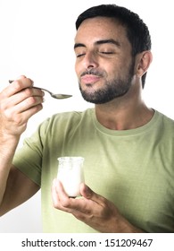 Happy Young Man With Beard Eating Yogurt Isolated On White Background