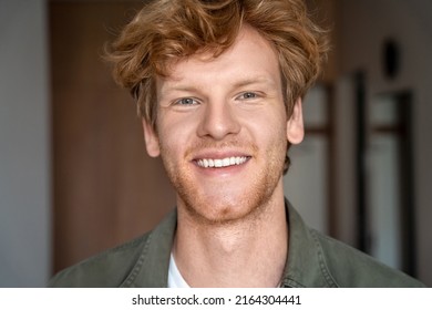 Happy Young Man With Beard And Messy Red Haircut Closeup Face Portrait. Millennial Ginger Male Student Or Freelance Employee Smiling With White Teeth And Cheerful Expression Looking At Camera