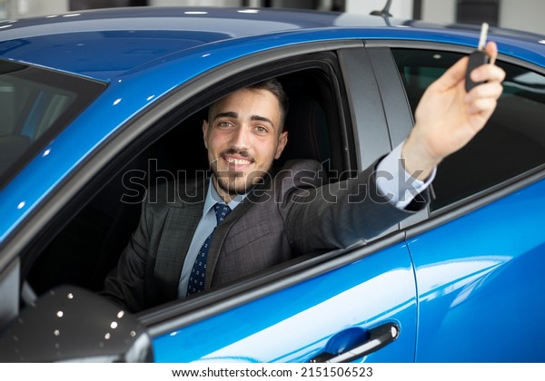 happy young man buying a \
in new car