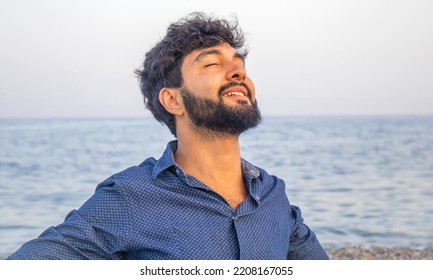 Happy Young Man Deep Breathing Fresh Air On The Beach