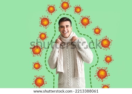 Happy young man and drawn virus on green background. Concept of strong immunity
