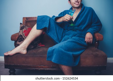 Happy Young Man In Dressing Gown Drinking Cocktails