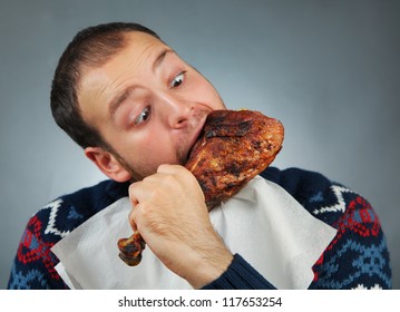 Happy Young Man Eating Meat