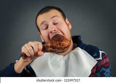 Happy Young Man Eating Meat