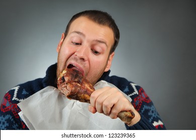 Happy Young Man Eating Meat