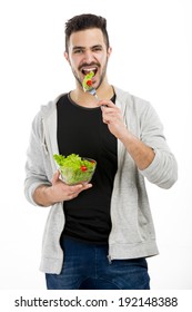 Happy Young Man Eating A Salad, Isolated On White Background