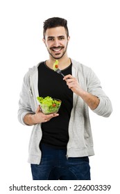 Happy Young Man Eating A Salad, Isolated On White Background