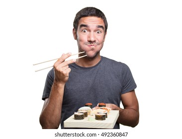 Happy Young Man Eating Sushi