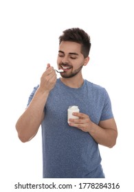 Happy Young Man Eating Tasty Yogurt On White Background