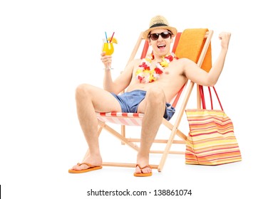 Happy Young Man Enjoying A Cocktail And Sitting On A Beach Chair, Isolated On White Background