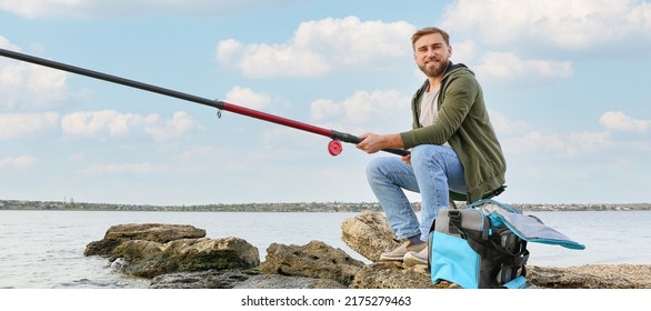 Happy Young Man Fishing On River