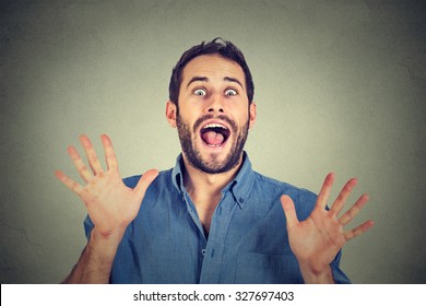 Happy Young Man Going Crazy Screaming Super Excited Isolated On Gray Wall Background 