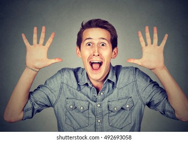 Happy Young Man Going Crazy Screaming Super Excited Surprised Isolated On Gray Background