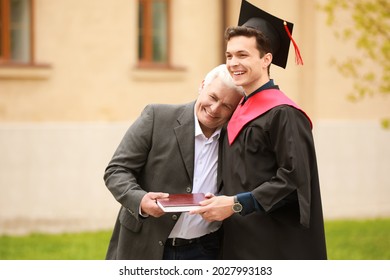 Happy Young Man With His Father On Graduation Day