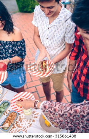 Similar – Mann hält Hot Dog im Barbecue mit Freunden.