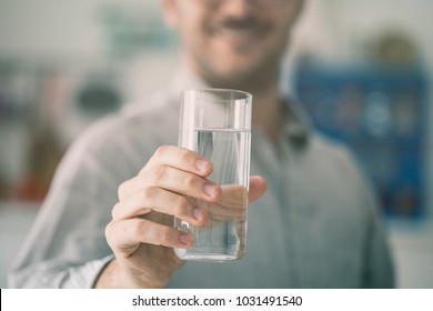 Happy Young Man Holding Glass Of Water Inside