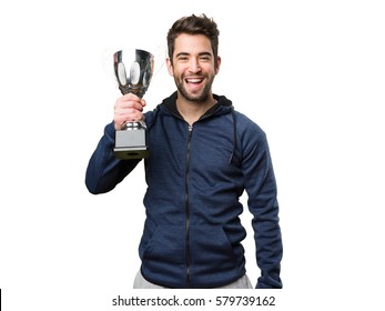 Happy Young Man Holding A Trophy