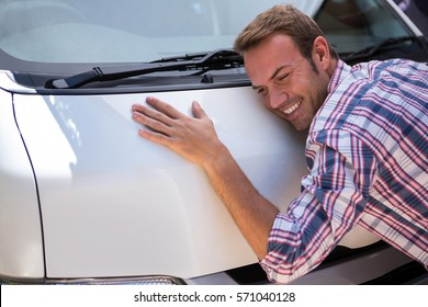 Happy Young Man Hugging His Car