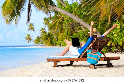 Happy Young Man With Laptop On Beach