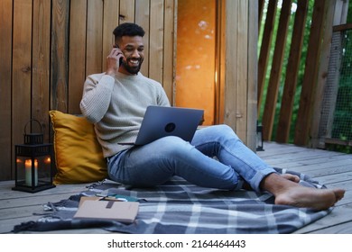 Happy Young Man With Laptop Resting Outdoors In A Tree House, Weekend Away And Remote Office Concept.