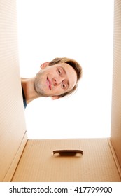 Happy Young Man Looking Inside Box