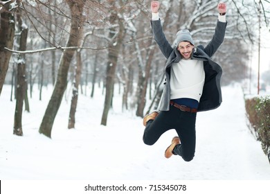 Happy Young Man On Winter Park Jumping Have Joy