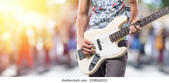 Happy Young Man Playing Guitar Outside The Home