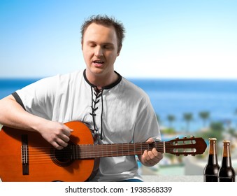 Happy Young Man Playing Guitar Outside The Home