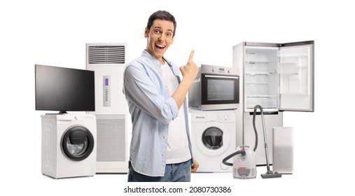 Happy young man pointing at home appliances isolated on white background - Shutterstock ID 2080730386