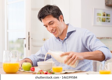 Happy Young Man Pouring Milk Into Bowl For Breakfast - Powered by Shutterstock