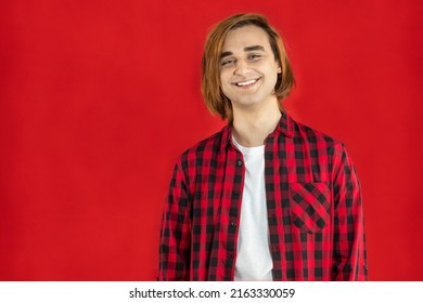 Happy Young Man Prep Student With Long Hair. Portrait Of A Guy Red Background.