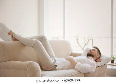 Happy Young Man Resting On Sofa